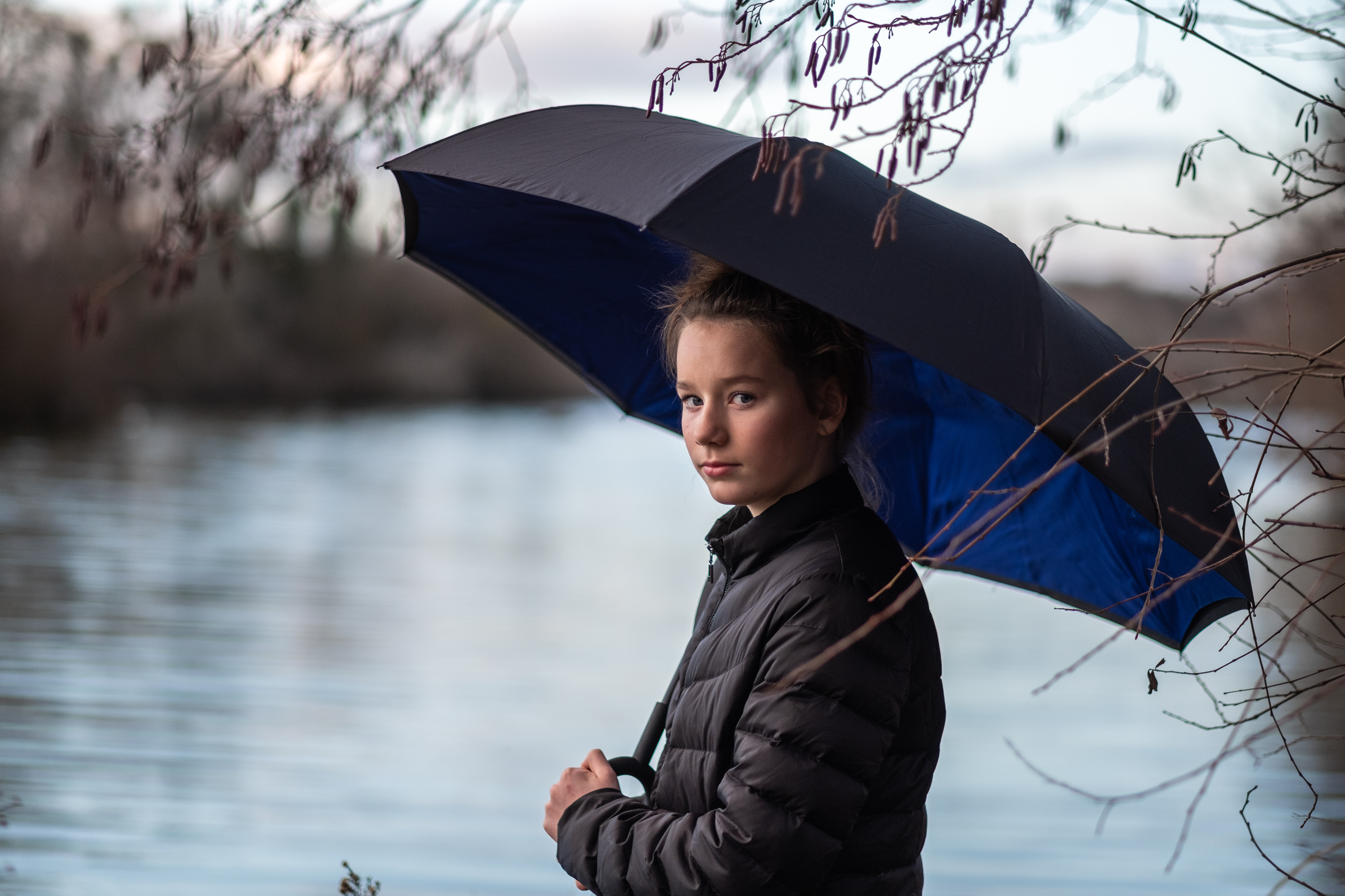 Outdoor portrait of a young girl with an umbrella