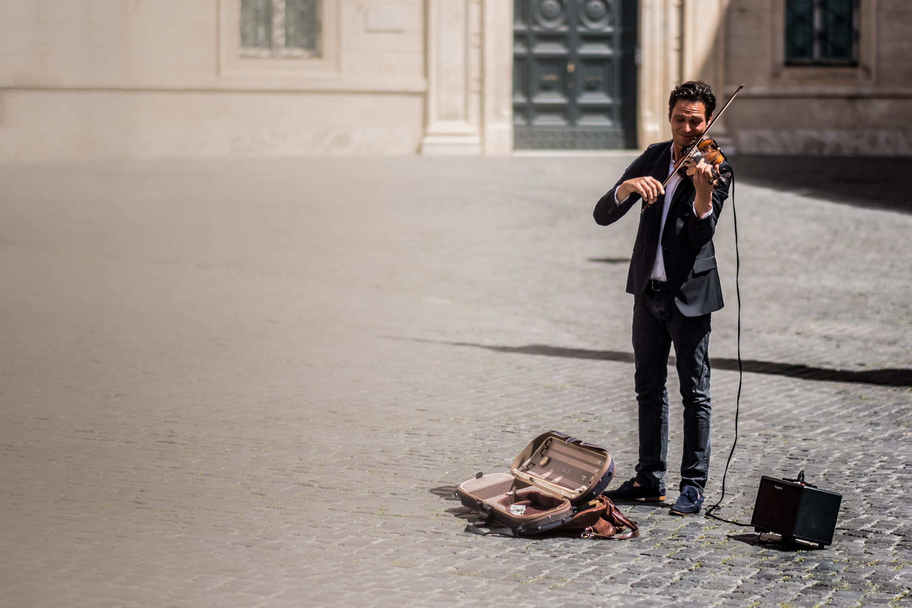 Photo of a violinist on a square in Rome.